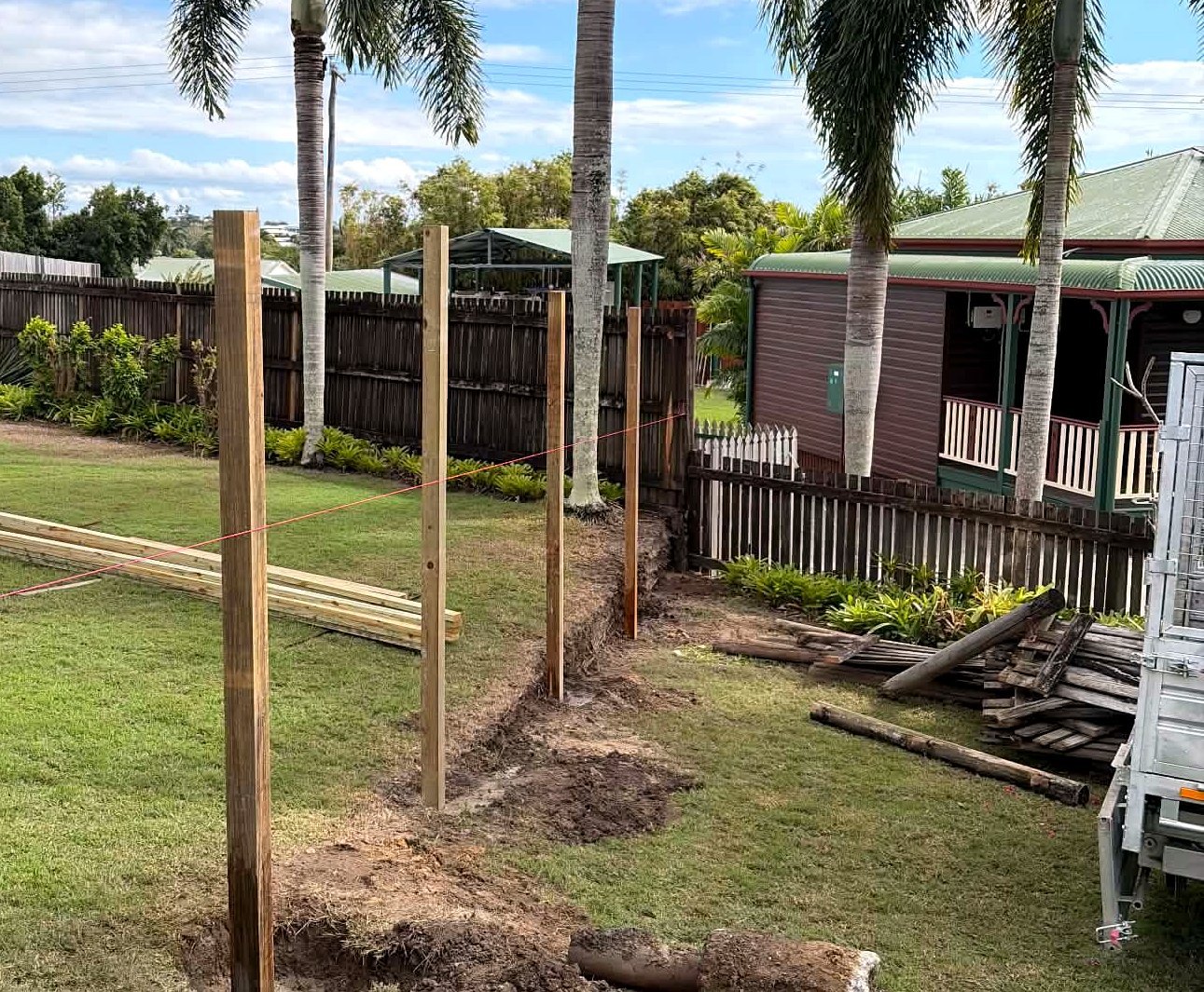 Timber fence posts set and concreted in a Mackay backyard